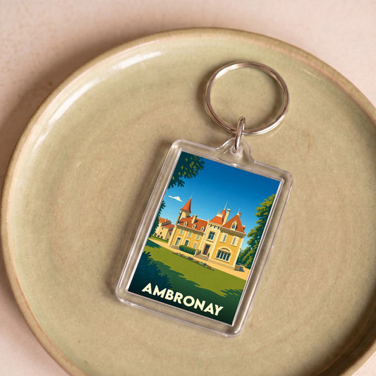 Porte-clés souvenir de la ville d'Ambronay avec une illustration stylisée d'un château.