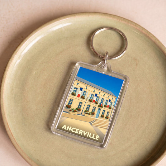 Porte-clés souvenir de la ville d'Ancerville avec une illustration stylisée de sa mairie.
