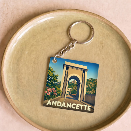 Porte-clés souvenir de la ville d'Andancette avec une illustration stylisée d'un pont suspendu.