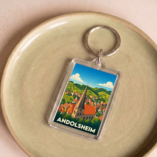 Porte-clés souvenir de la ville d'Andolsheim avec une illustration stylisée.