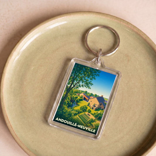 Porte-clés souvenir de la ville d'Andouillé-Neuville avec une illustration bucolique stylisée.
