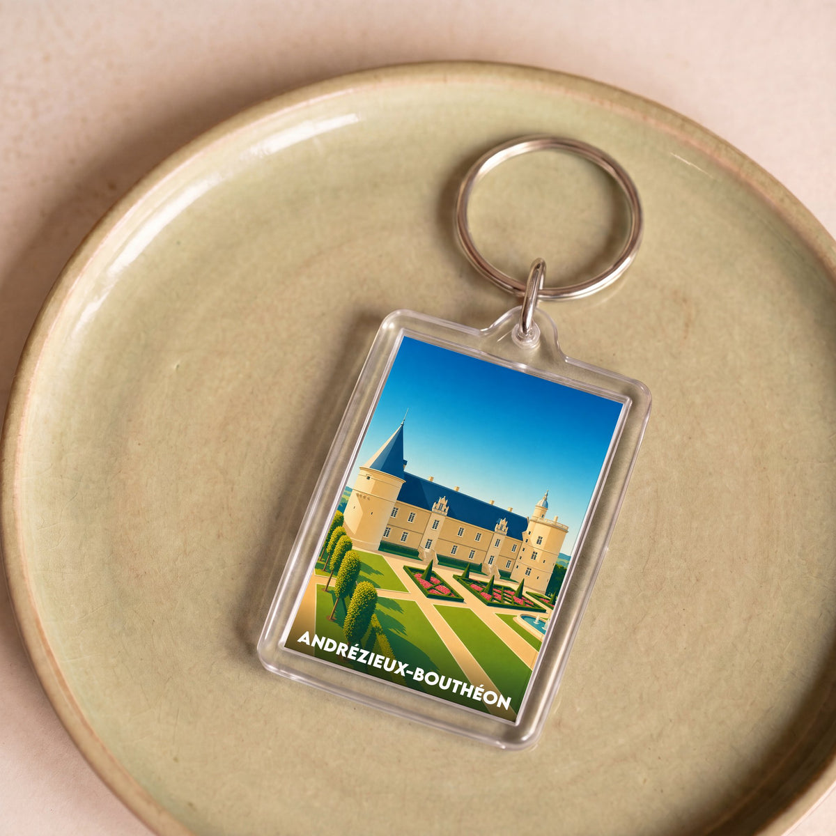 Porte-clés souvenir de la ville de Andrézieux-Bouthéon avec une illustration stylisée de son château.