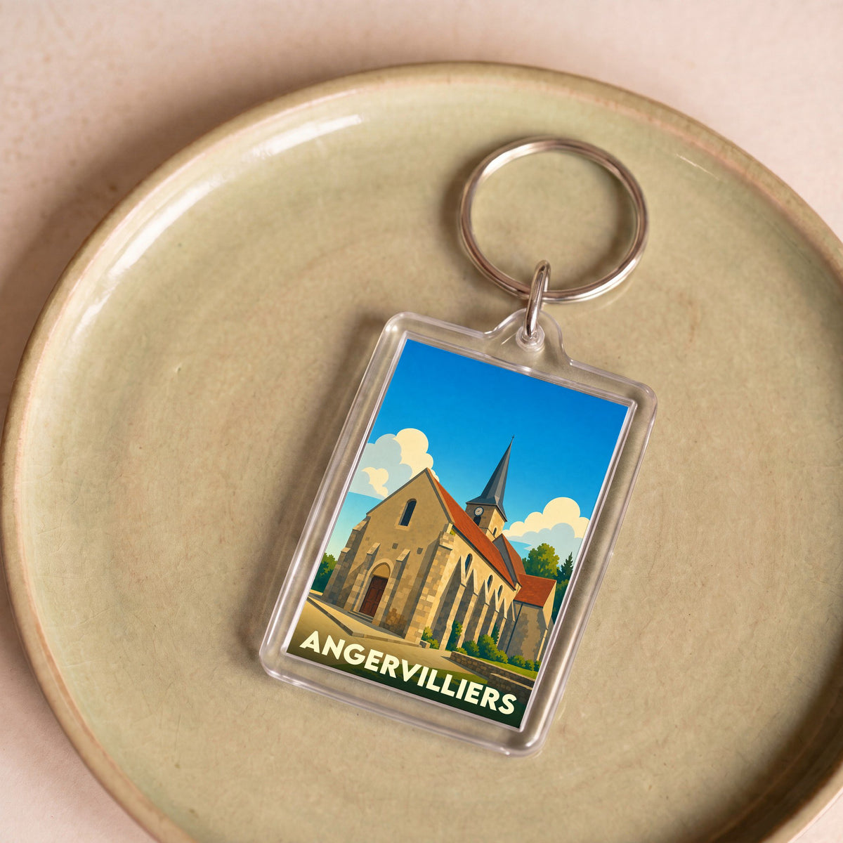 Porte-clés souvenir de la ville d'Angervilliers avec une illustration stylisée de son église.