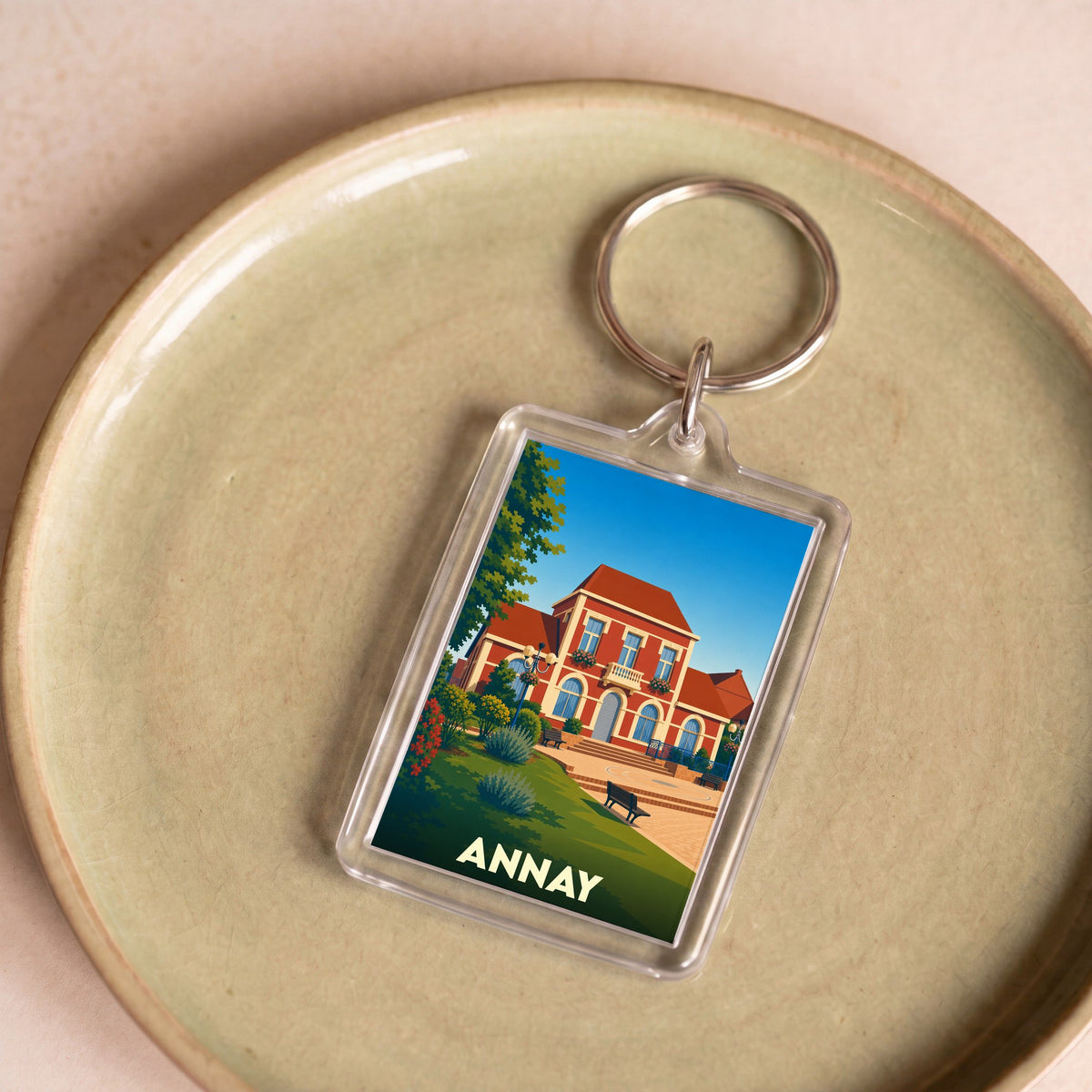 Porte-clés souvenir de la ville d'Annay avec une illustration stylisée de son hôtel de ville.