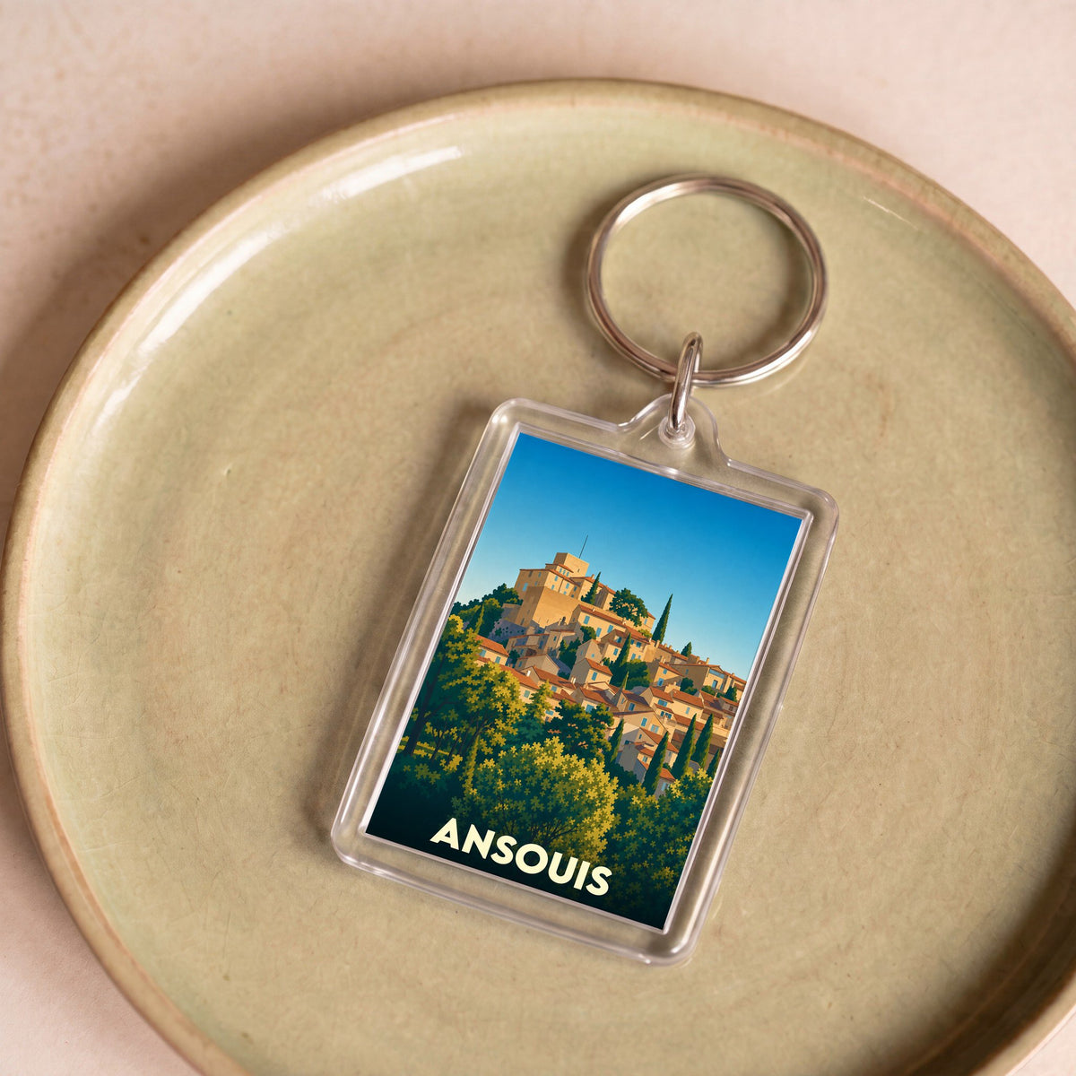 Porte-clés souvenir de la ville d'Ansouis avec une illustration stylisée.