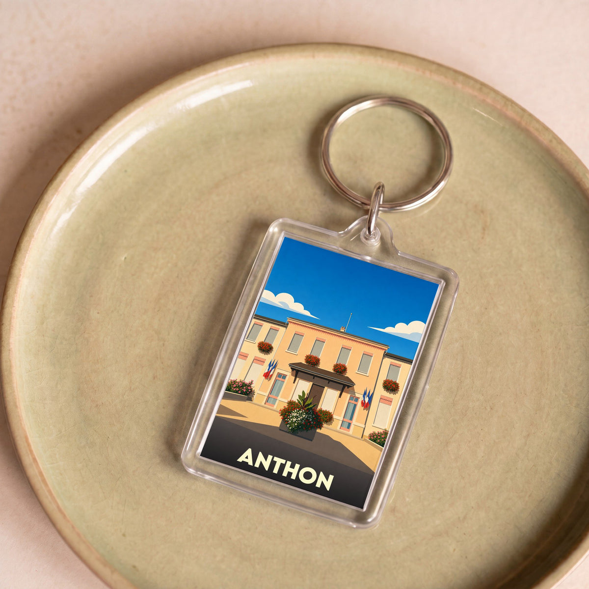 Porte-clés souvenir de la ville de Anthon avec une illustration stylisée de sa mairie.