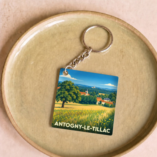 Porte-clés souvenir de la ville de Antogny-le-Tillac avec une illustration champêtre stylisée.