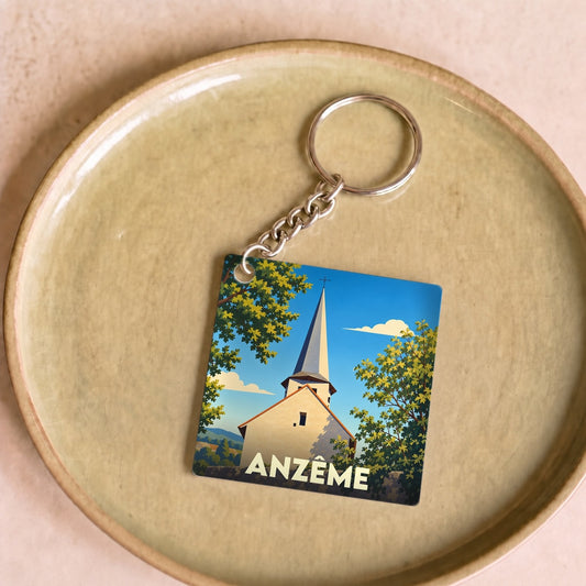 Porte-clés souvenir de la ville d'Anzême avec une illustration stylisée de son église.