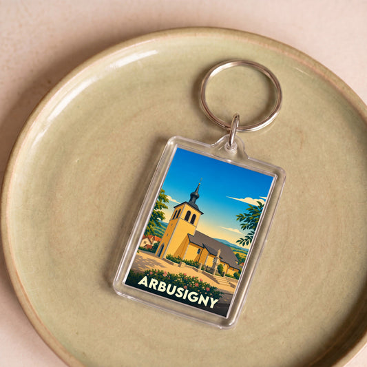Porte-clés souvenir de la ville d'Arbusigny avec une illustration stylisée de son église.
