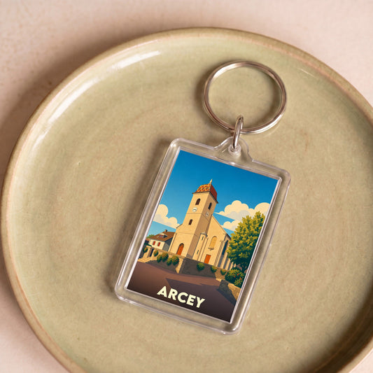 Porte-clés souvenir de la ville de Arcey avec une illustration stylisée de son église.
