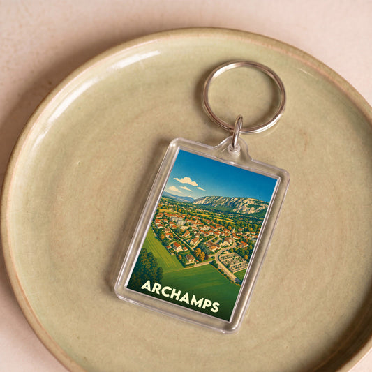 Porte-clés souvenir de la ville d'Archamps avec une illustration stylisée.