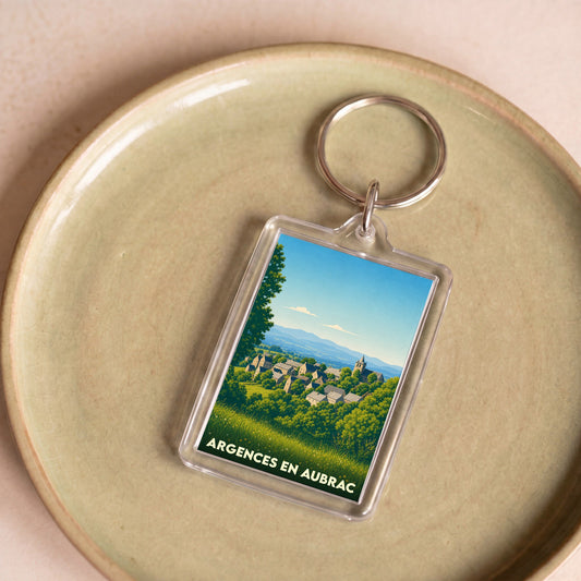 Porte-clés souvenir de la ville de Argences en Aubrac avec une illustration stylisée.