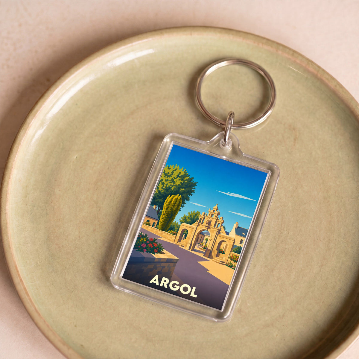 Porte-clés souvenir de la ville d'Argol avec une illustration stylisée de son enclos paroissial.