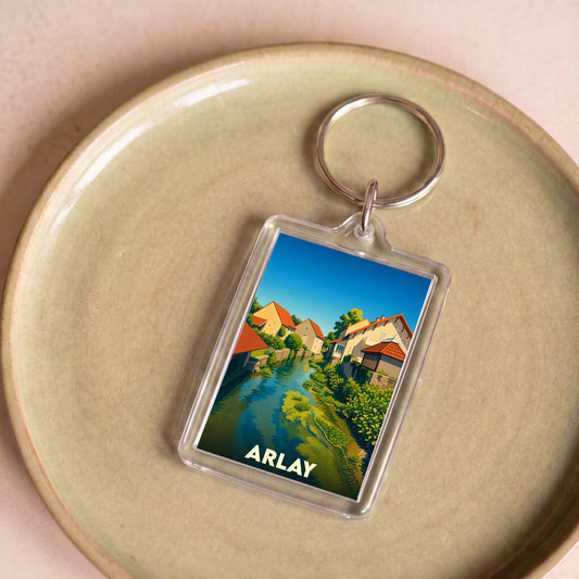 Porte-clés souvenir de la ville d'Arlay avec une illustration stylisée.