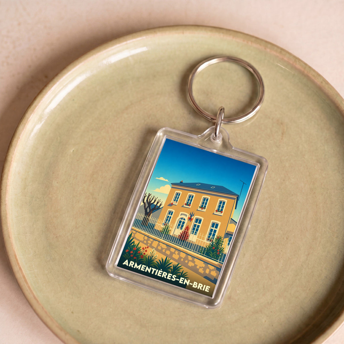 Porte-clés souvenir de la ville d'Armentières-en-Brie avec une illustration stylisée.