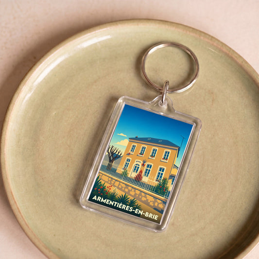 Porte-clés souvenir de la ville d'Armentières-en-Brie avec une illustration stylisée.