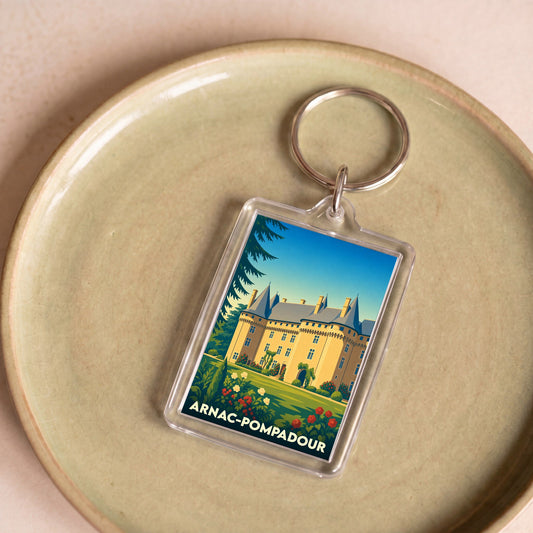 Porte-clés souvenir de la ville d'Arnac-Pompadour avec une illustration stylisée de son château.