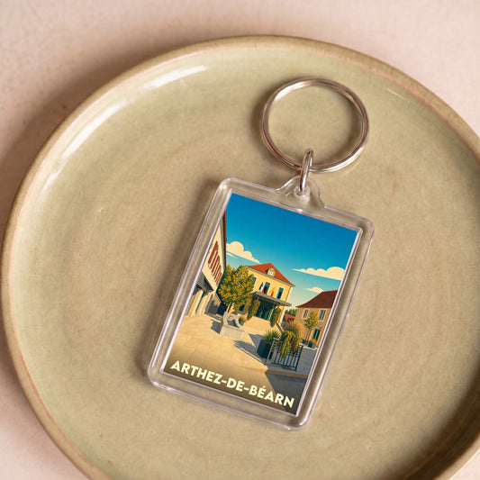Porte-clés souvenir de la ville de Arthez-de-Béarn avec une illustration stylisée.