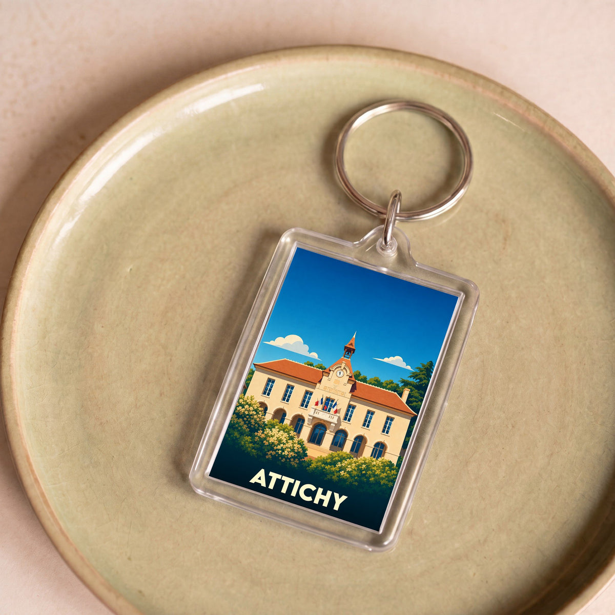 Porte-clés souvenir de la ville de Attichy avec une illustration stylisée de sa mairie.