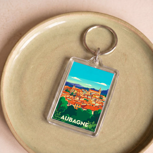 Porte-clés souvenir de la ville d'Aubagne avec une illustration stylisée.