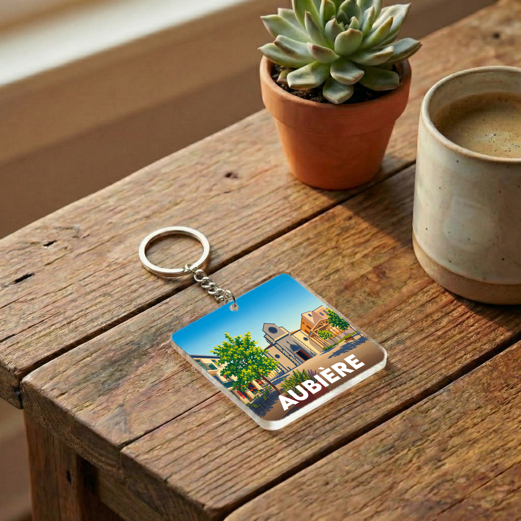 Porte-clés souvenir de la ville d'Aubière avec une illustration stylisée.
