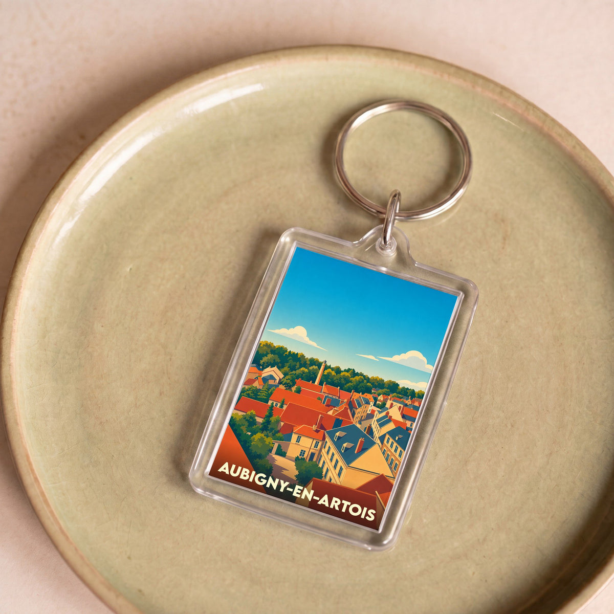 Porte-clés souvenir de la ville d'Aubigny-en-Artois avec une illustration stylisée.