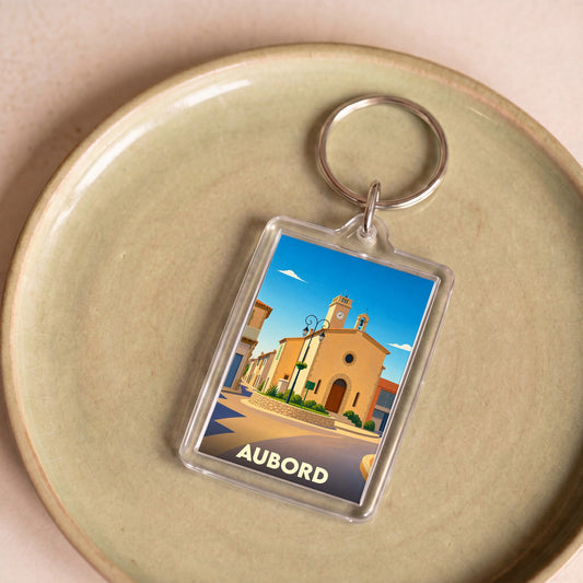 Porte-clés souvenir de la ville de Aubord avec une illustration stylisée de son église.
