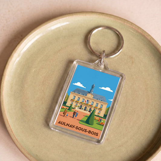 Porte-clés souvenir de la ville d'Aulnay-sous-Bois avec une illustration stylisée.