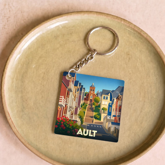 Porte-clés souvenir de la ville d'Ault avec une illustration stylisée de ses rues et de son église.
