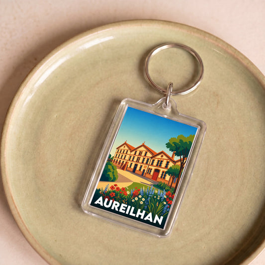 Porte-clés souvenir de la ville d'Aureilhan avec une illustration stylisée.