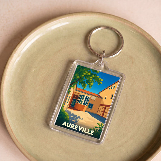 Porte-clés souvenir de la ville de Aureville avec une illustration stylisée et colorée.