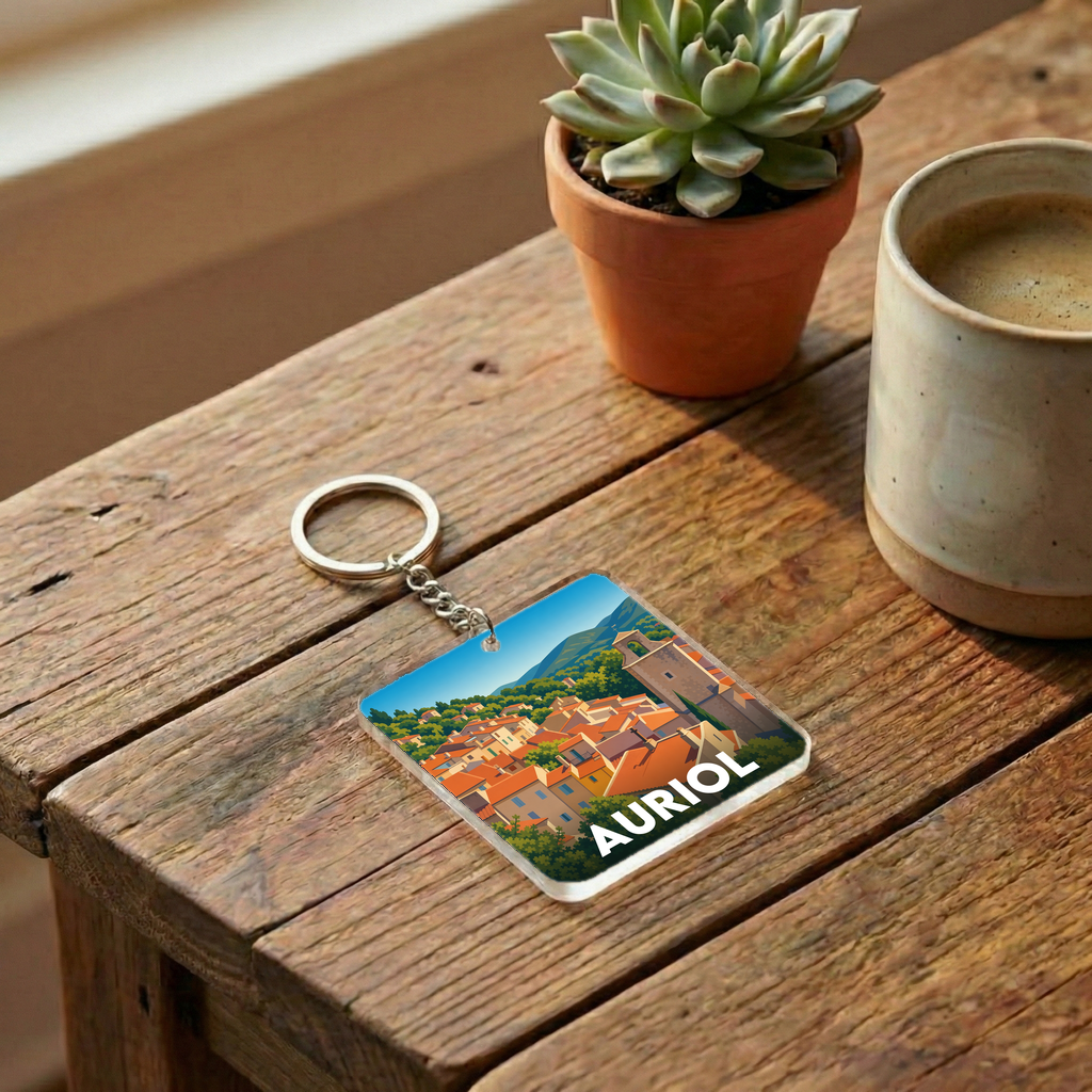 Porte-clés souvenir de la ville d'Auriol avec une illustration stylisée.