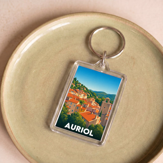 Porte-clés souvenir de la ville d'Auriol avec une illustration stylisée.