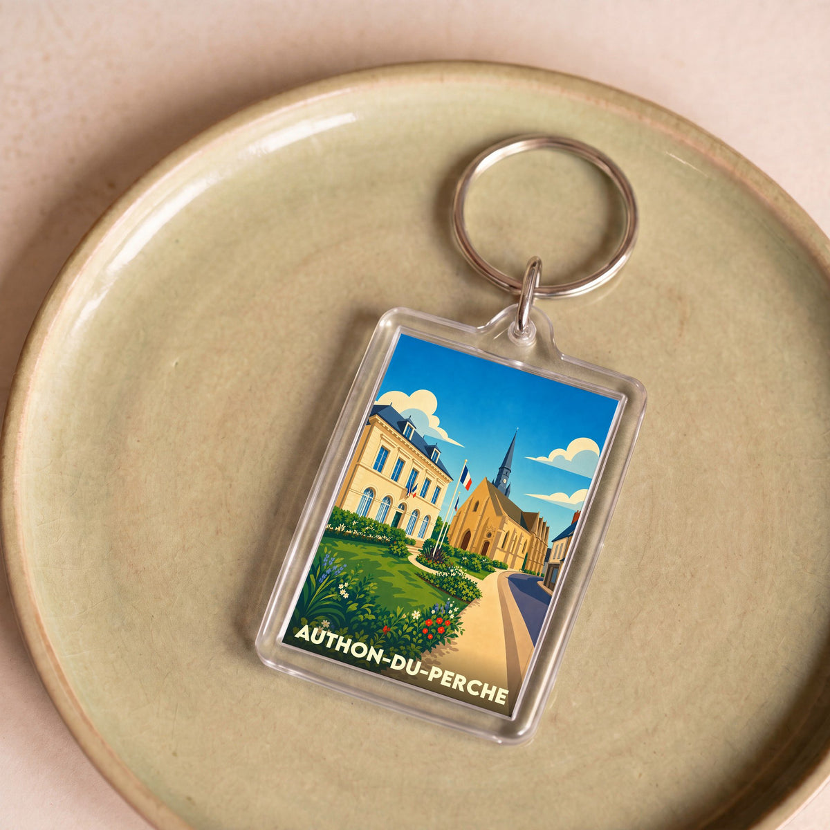 Porte-clés souvenir de la ville d'Authon-du-Perche avec une illustration stylisée.