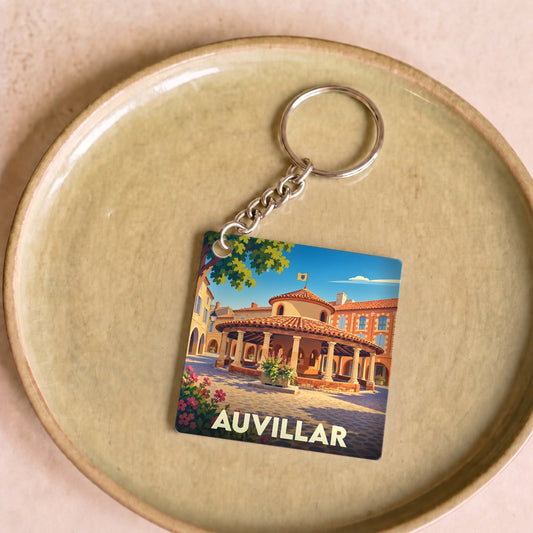 Porte-clés souvenir de la ville d'Auvillar avec une illustration stylisée de sa halle circulaire.