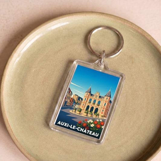 Porte-clés souvenir de la ville d'Auxi-le-Château avec une illustration stylisée de son architecture.