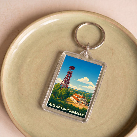 Porte-clés souvenir de la ville d’Auzat-la-Combelle avec une illustration stylisée de son chevalement minier.
