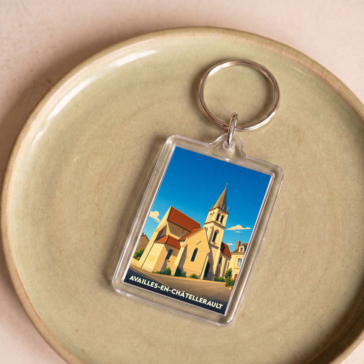 Porte-clés souvenir de la ville de Availles-en-Châtellerault avec une illustration stylisée de son église.