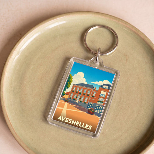 Porte-clés souvenir de la ville d'Avesnelles avec une illustration stylisée.