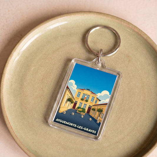 Porte-clés souvenir de la ville de Ayguemorte-les-Graves avec une illustration stylisée.