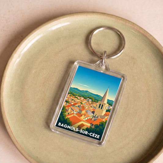 Porte-clés souvenir de la ville de Bagnols-sur-Cèze avec une illustration stylisée.