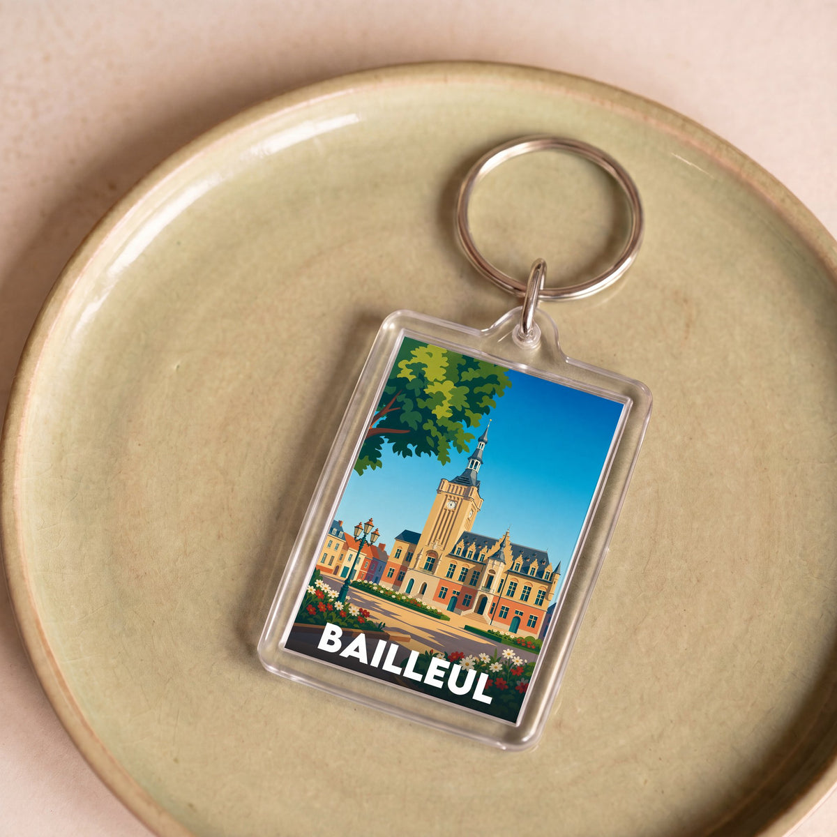 Porte-clés souvenir de la ville de Bailleul avec une illustration stylisée de son beffroi.