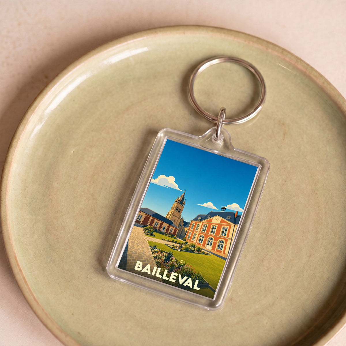 Porte-clés souvenir de la ville de Bailleval avec une illustration stylisée.