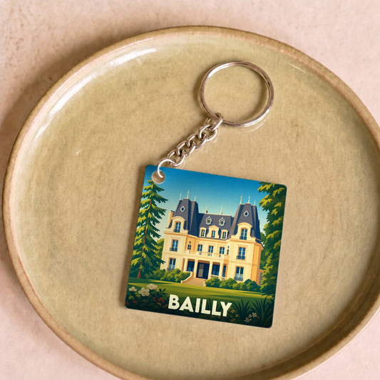 Porte-clés souvenir de la ville de Bailly avec une illustration stylisée d'un château.
