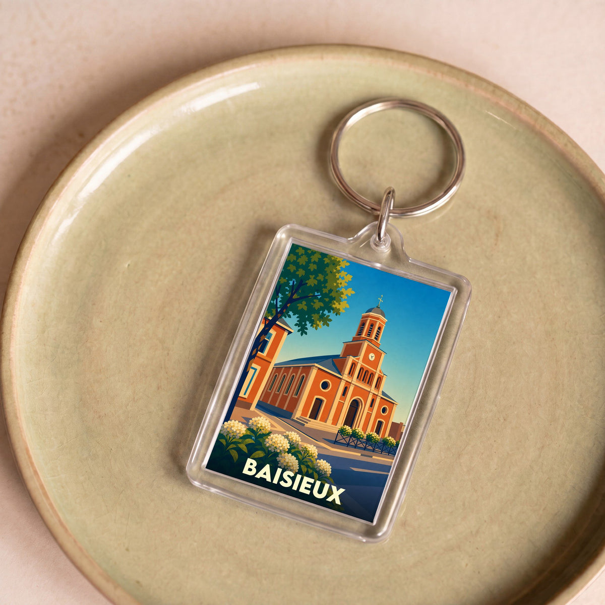 Porte-clés souvenir de la ville de Baisieux avec une illustration stylisée de son église.