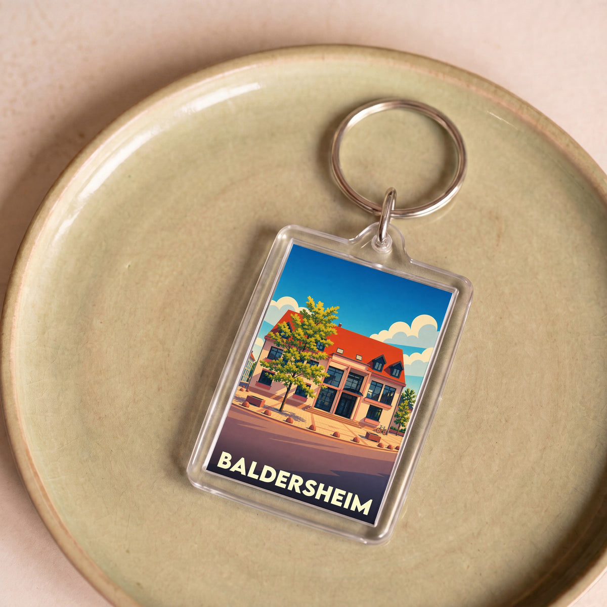 Porte-clés souvenir de la ville de Baldersheim avec une illustration stylisée.