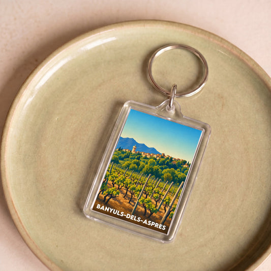 Porte-clés souvenir de la ville de Banyuls-dels-Aspres avec une illustration stylisée.