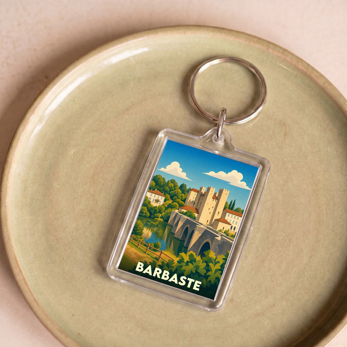 Porte-clés souvenir de la ville de Barbaste avec une illustration stylisée de son pont et de son moulin.