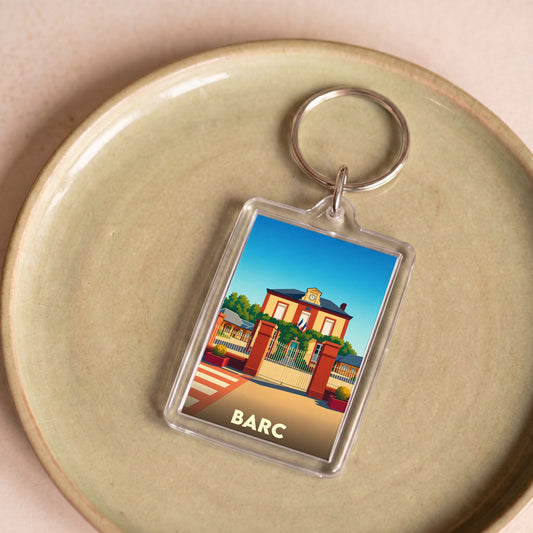 Porte-clés souvenir de la ville de Barc avec une illustration stylisée d'un bâtiment officiel.
