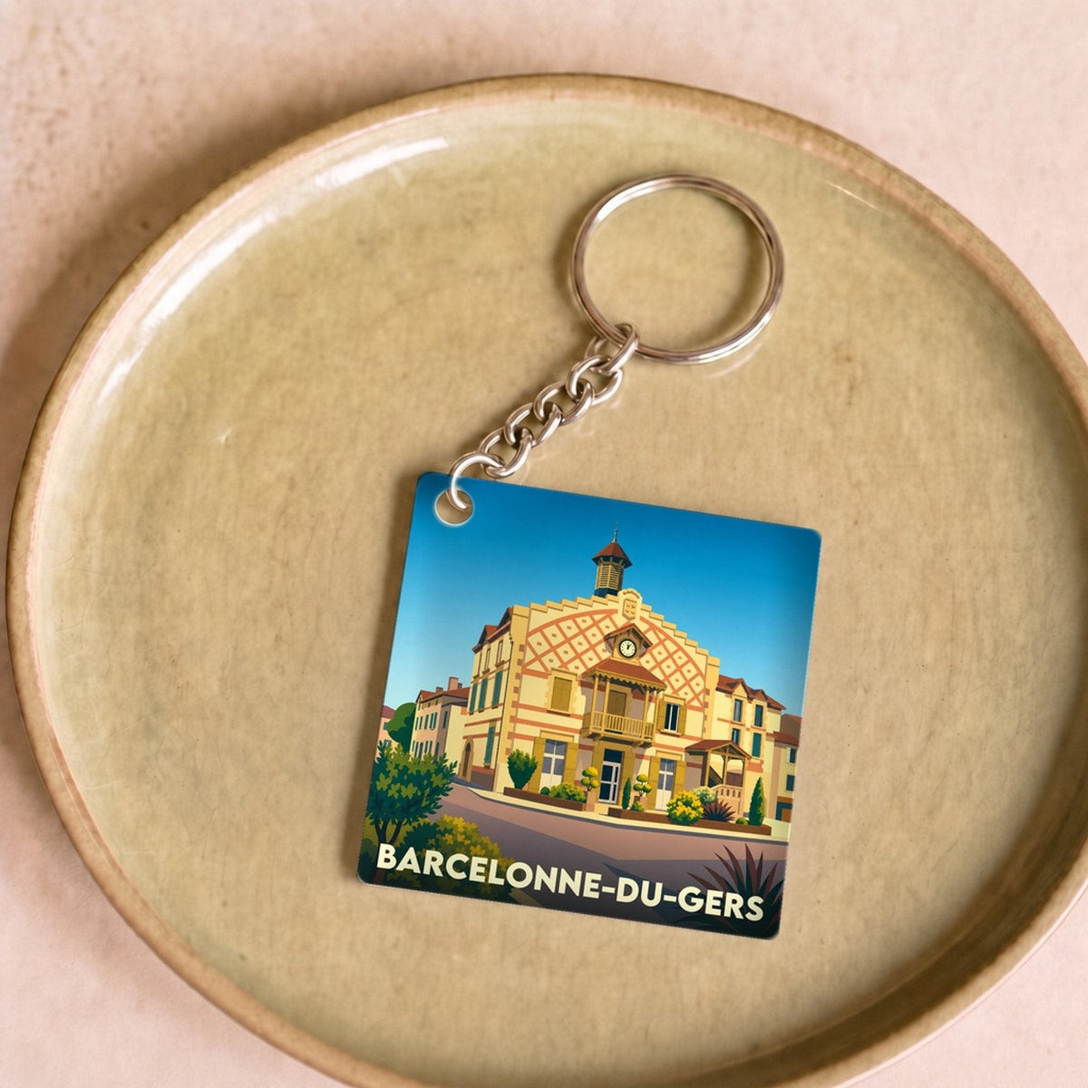 Porte-clés souvenir de la ville de Barcelonne-du-Gers avec une illustration stylisée.